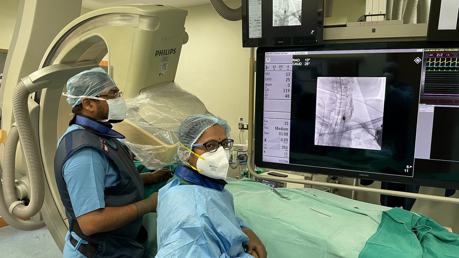 Doctors performing a fluoroscopy guided pain procedure in the C-arm suite